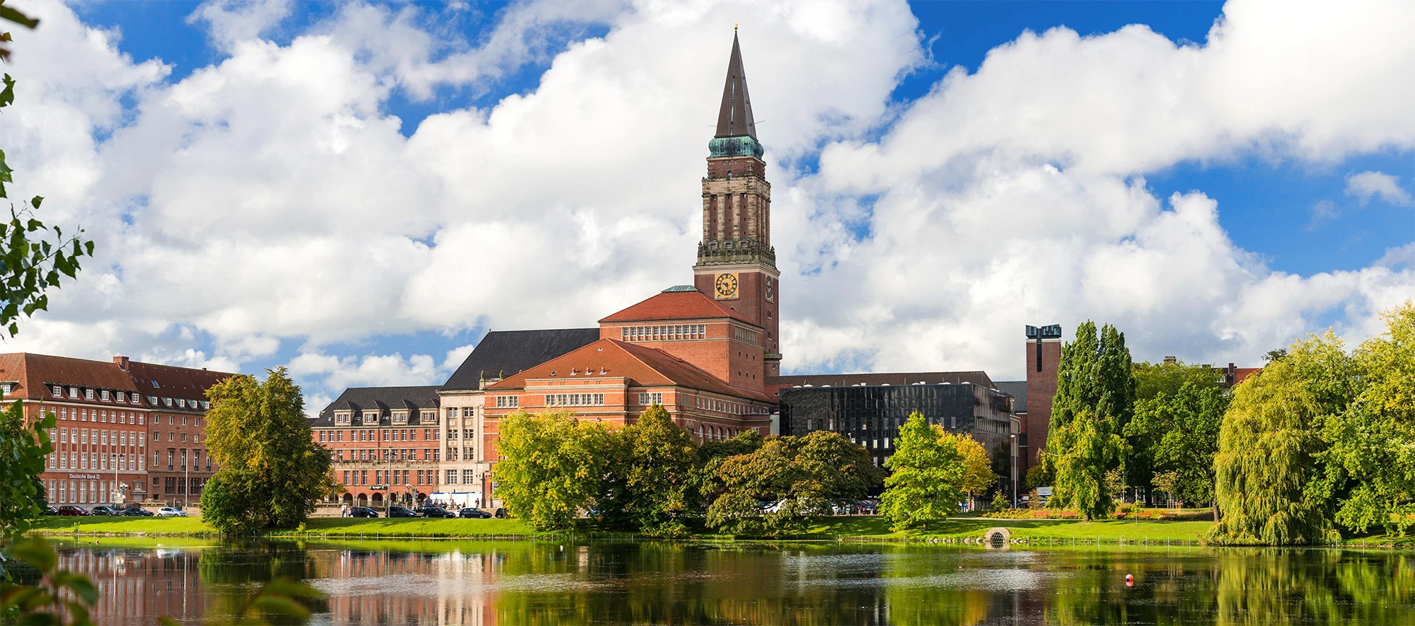 Kieler Rathaus mit Spiegelung im Kleinen Kiel bei sonnigem Wetter